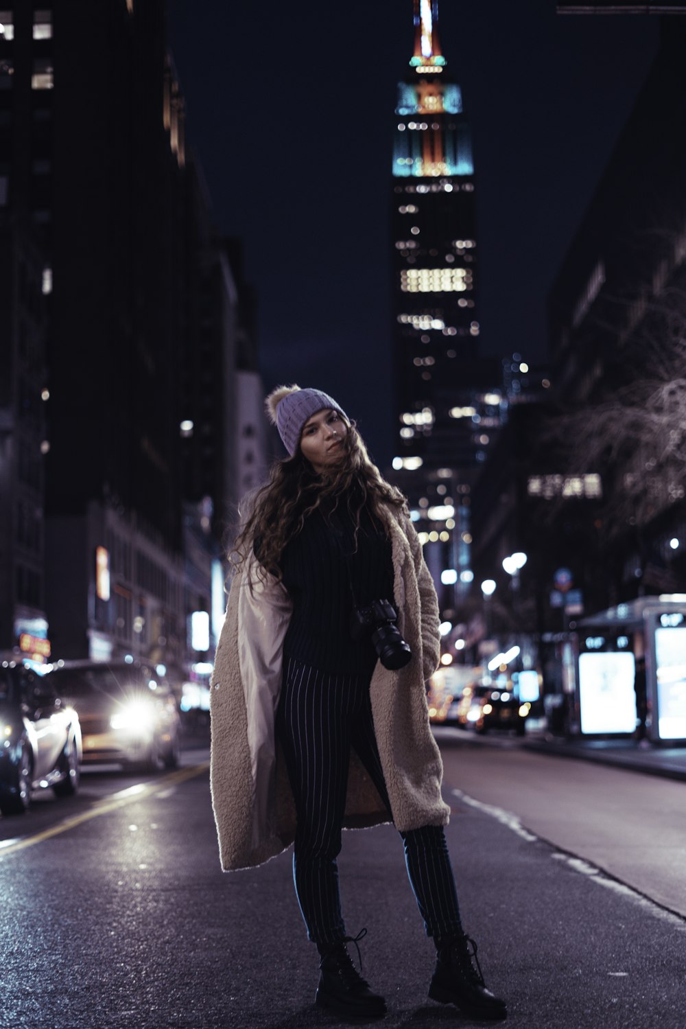 woman in black and white striped long sleeve shirt and gray knit cap standing on street