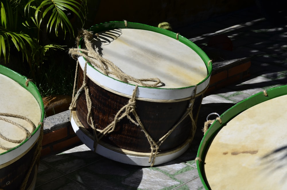 brown and green drum on white floor tiles