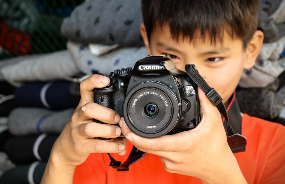 person holding black nikon dslr camera