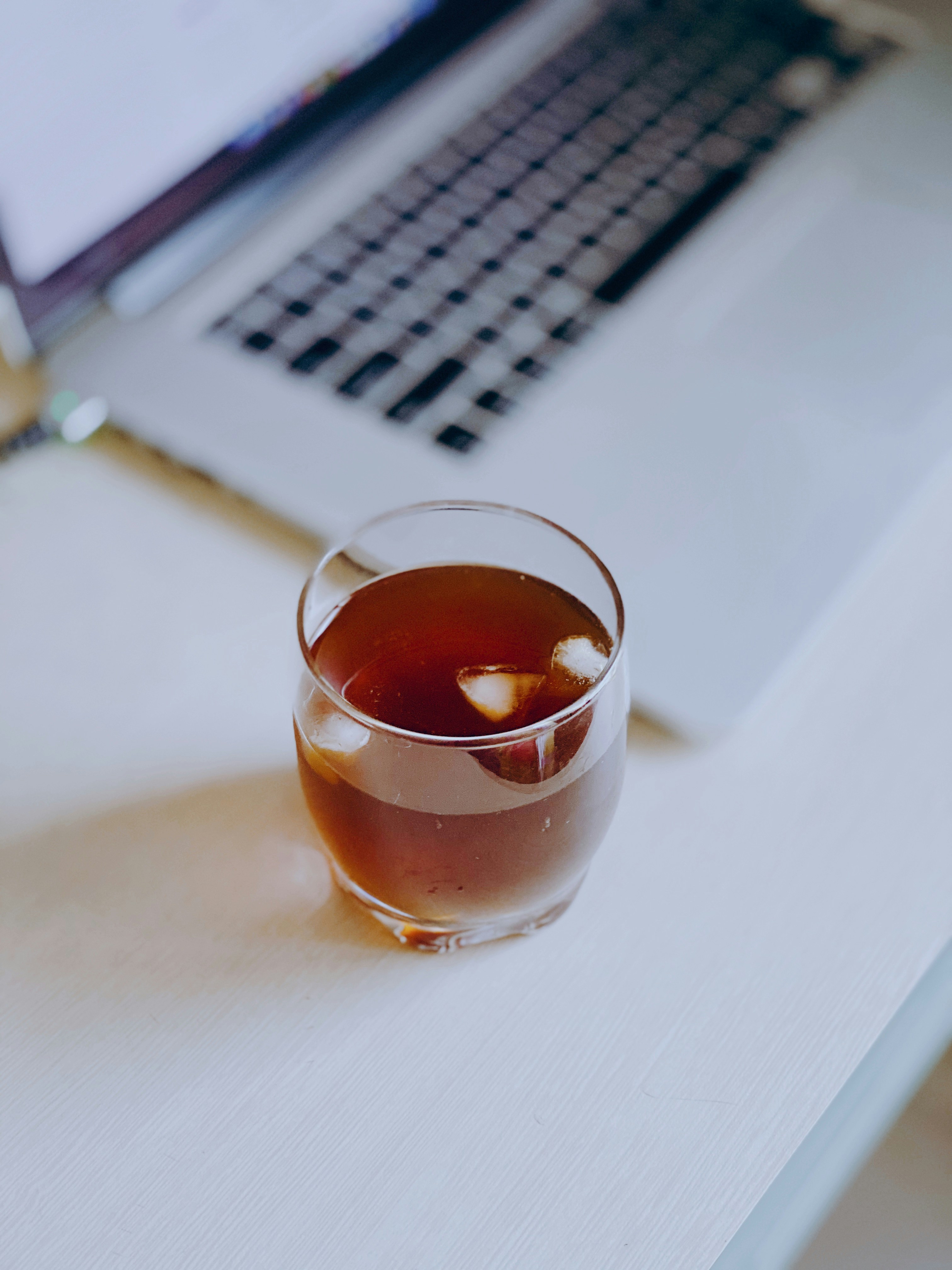 clear drinking glass with brown liquid inside
