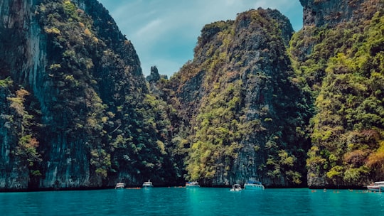 green and brown mountain beside body of water during daytime in Ko Phi Phi Lee Thailand