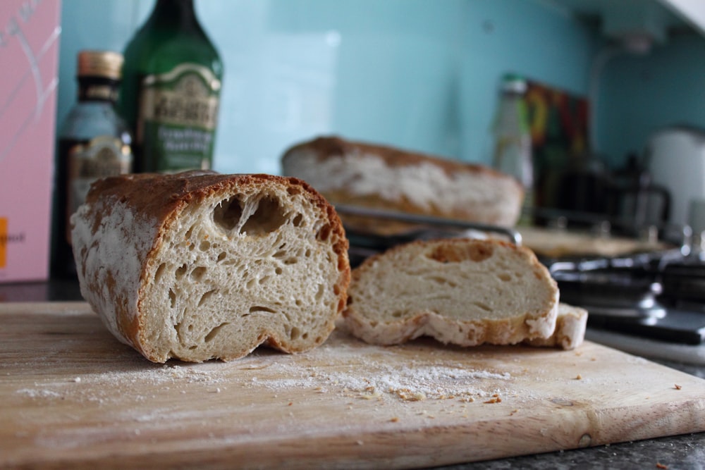 bread on white table near green glass bottle