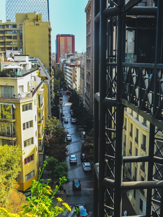 cars parked on side of road near buildings during daytime in Santiago Chile