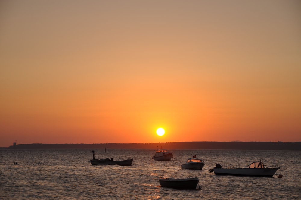 silhouette of people on beach during sunset