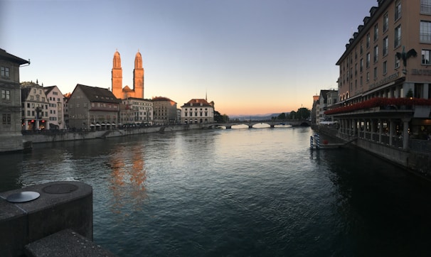 A serene view of the Sangam river confluence at sunset with the hotel in the foreground.