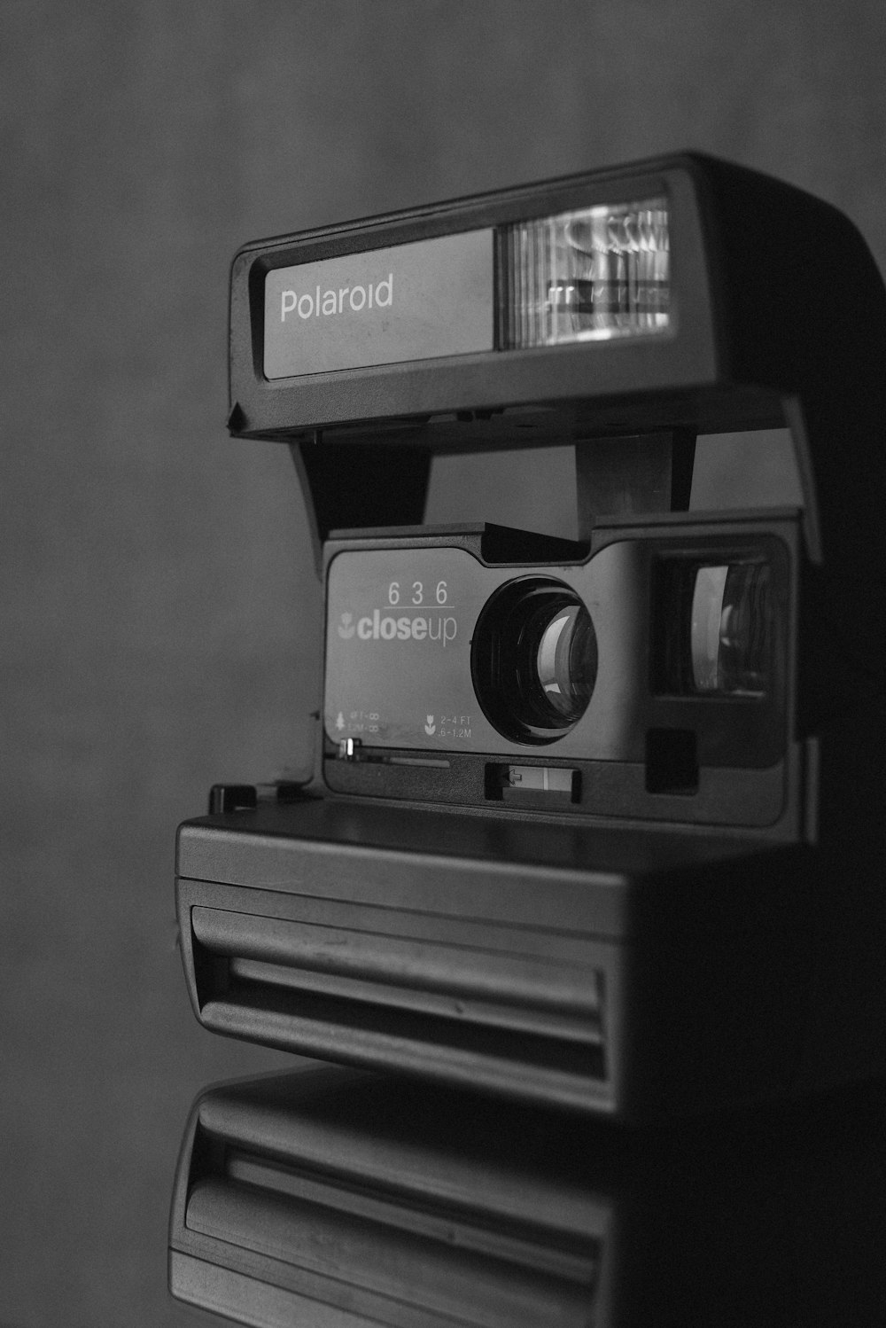 grayscale photo of polaroid instant camera