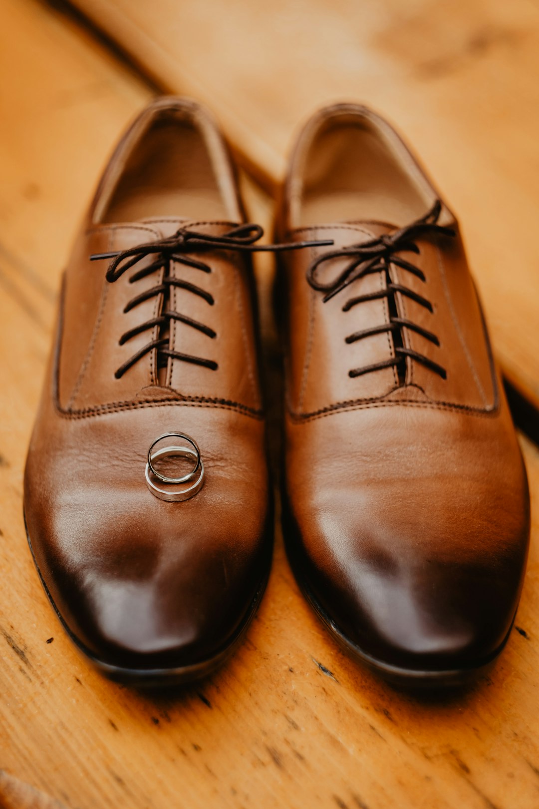 brown leather shoes on brown wooden table