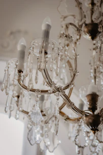 clear glass chandelier turned on in room