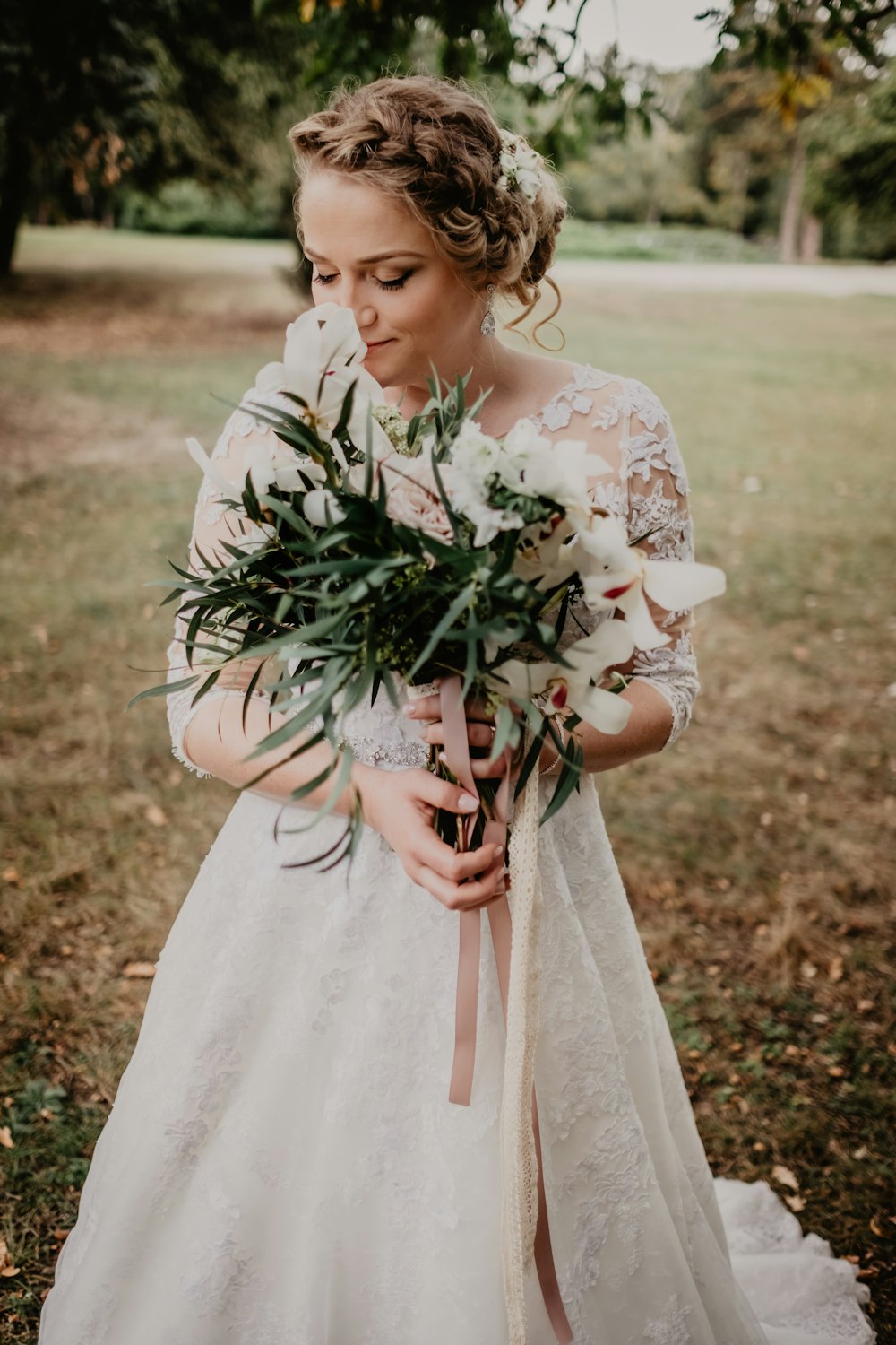 girl in white dress holding bouquet of flowers