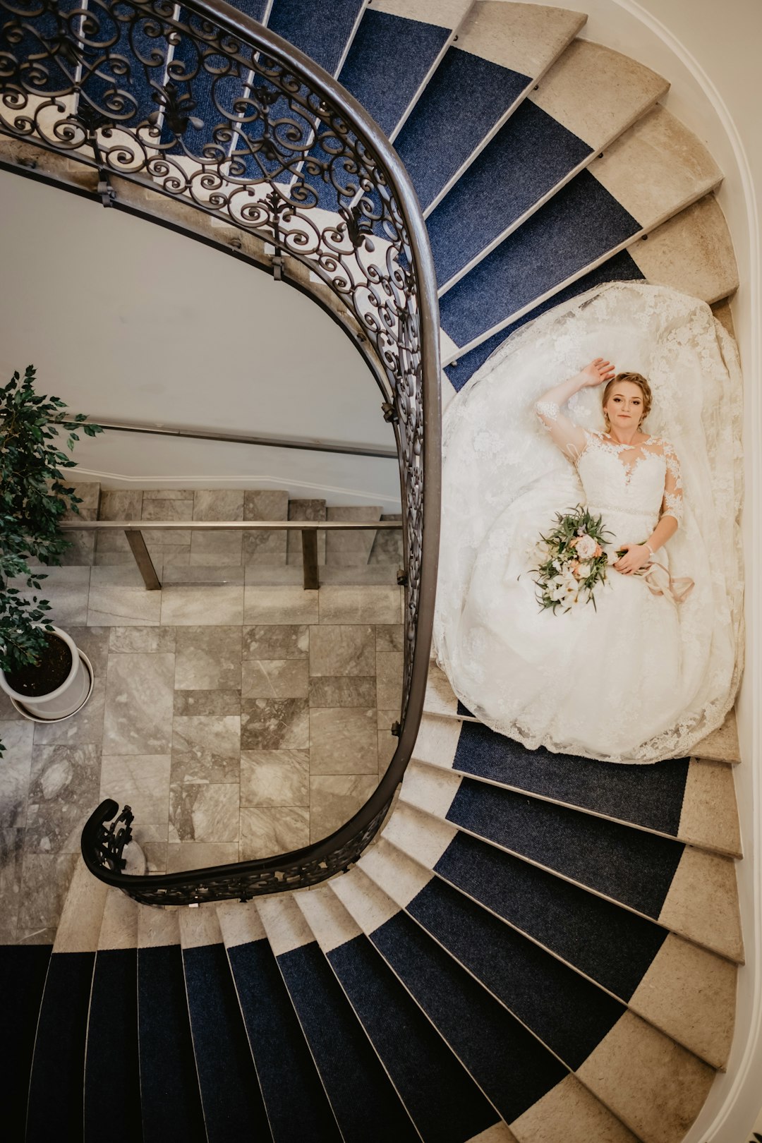 woman in white wedding dress standing on staircase