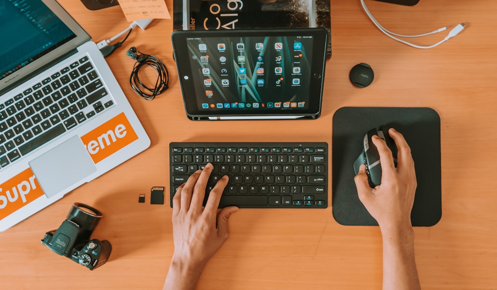 person using black tablet computer