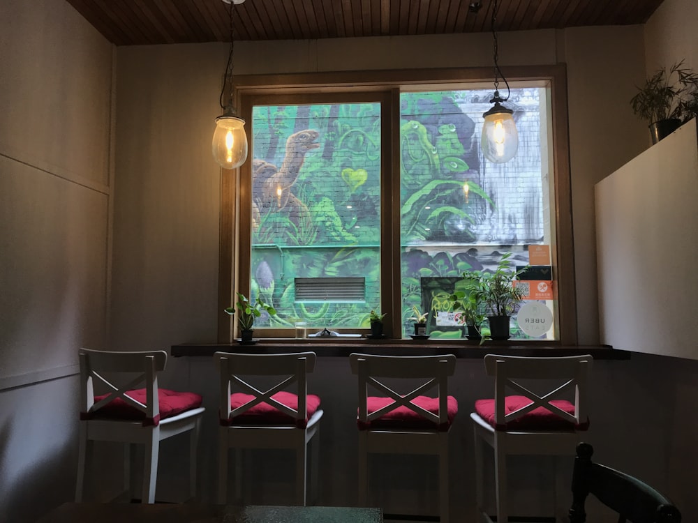 brown wooden table with chairs near window