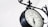 A vintage-style clock with Roman numerals, mounted on an ornate black metal bracket. The clock face reads 'Paddington Station London 1854' and is set against a clean, white background, giving a classic and elegant appearance.