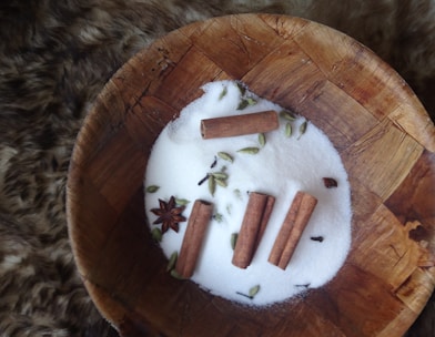 white cigarette butts on round brown wooden ashtray