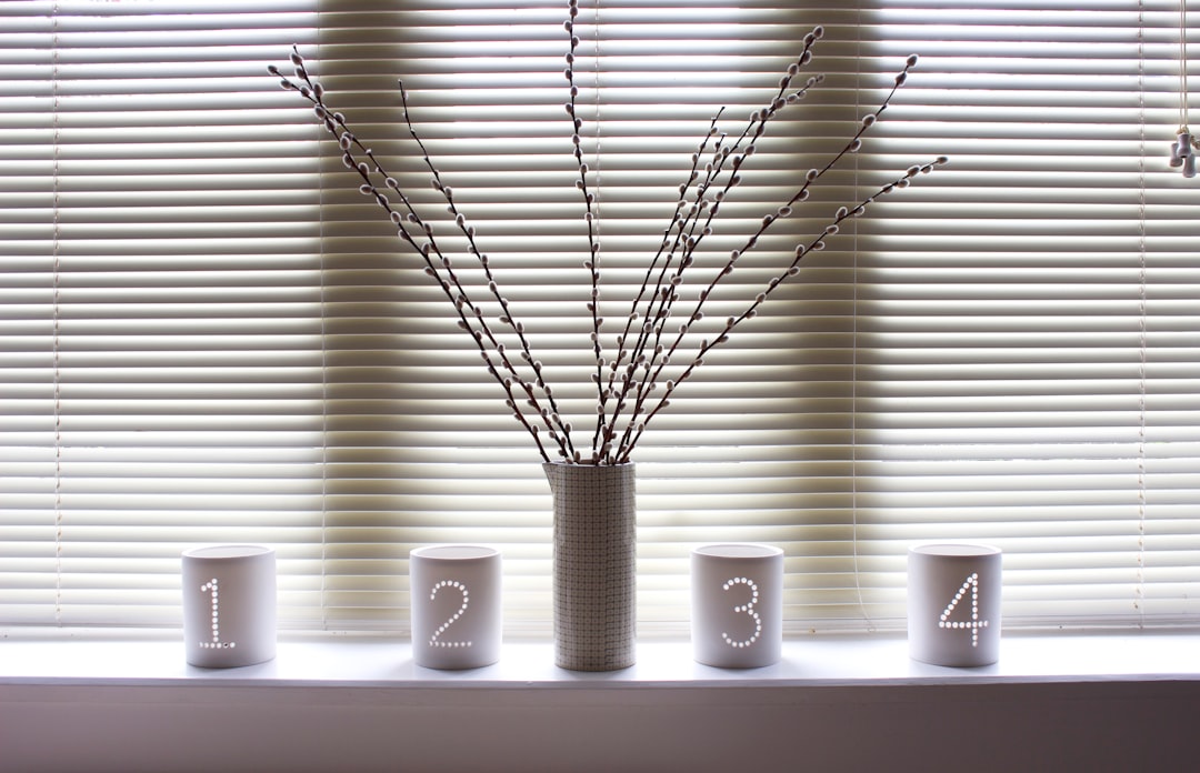 gray scale photo of plant in white ceramic pot