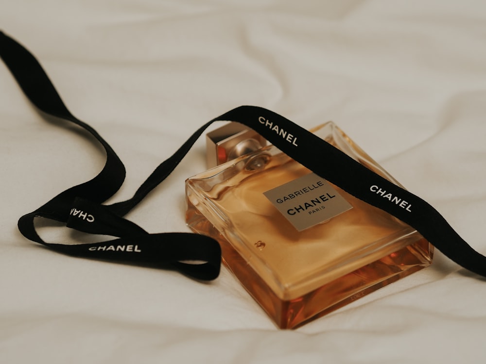 gold perfume bottle on white textile