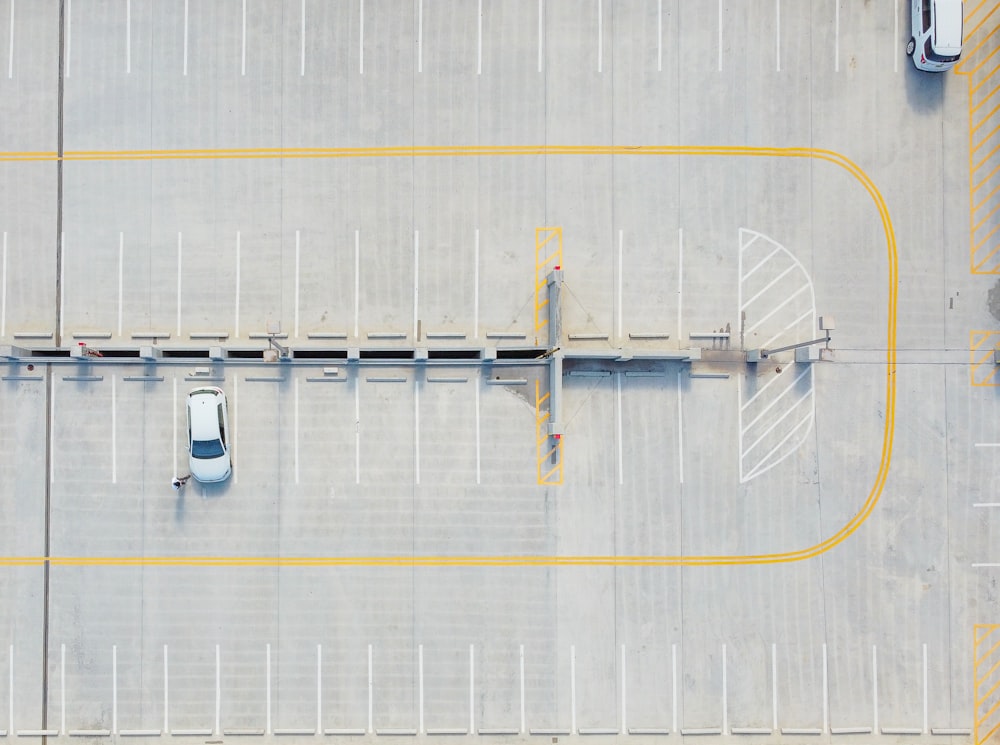 aerial view of white and yellow boat on dock during daytime