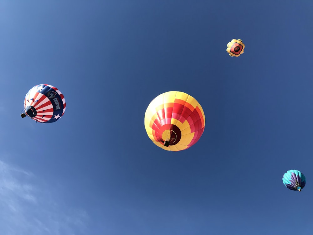 red blue and yellow hot air balloons in the sky
