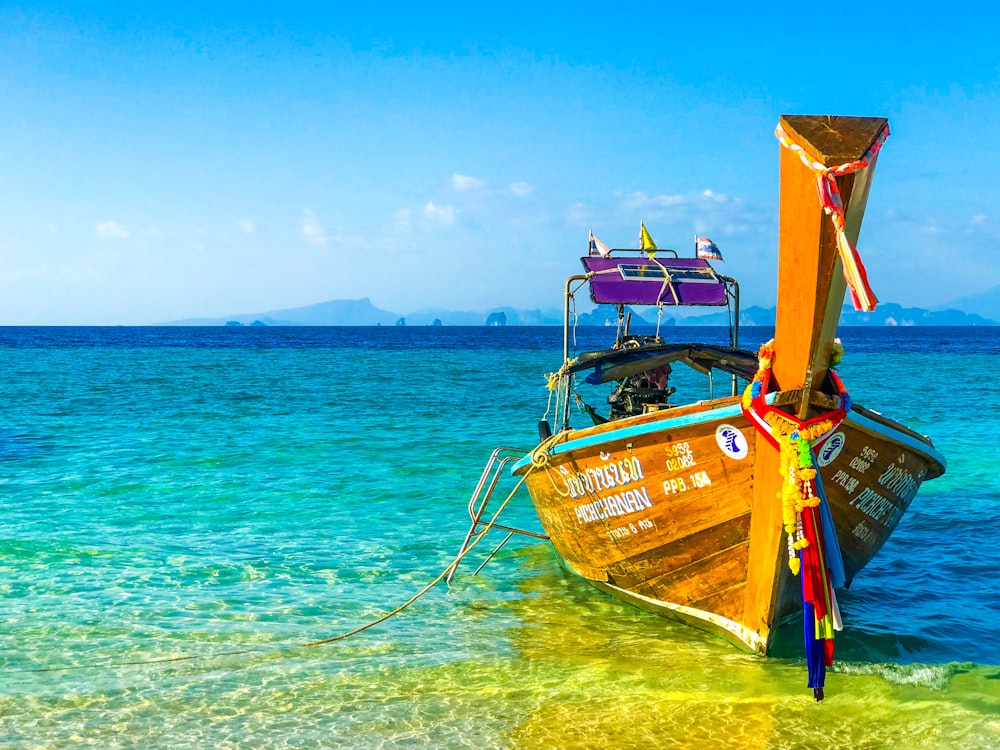 brown boat on body of water during daytime