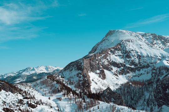 snow covered mountain under blue sky during daytime in Schönau am Königssee Germany