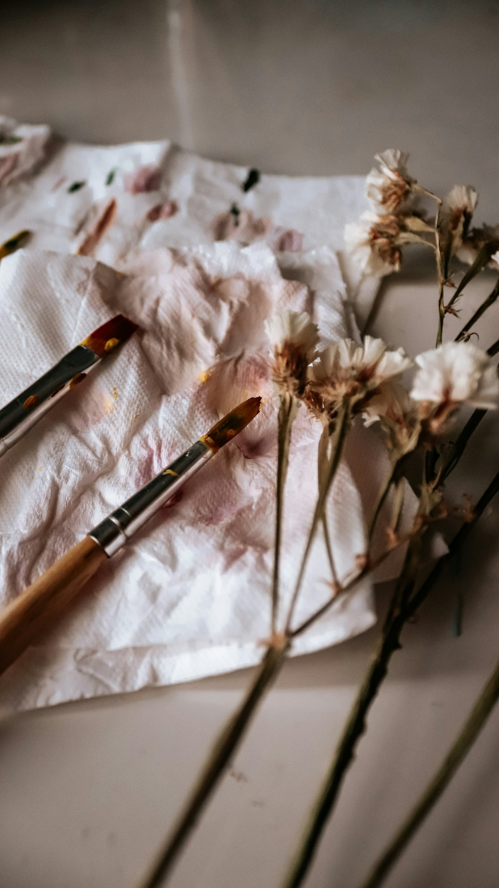 black and brown makeup brush on white textile