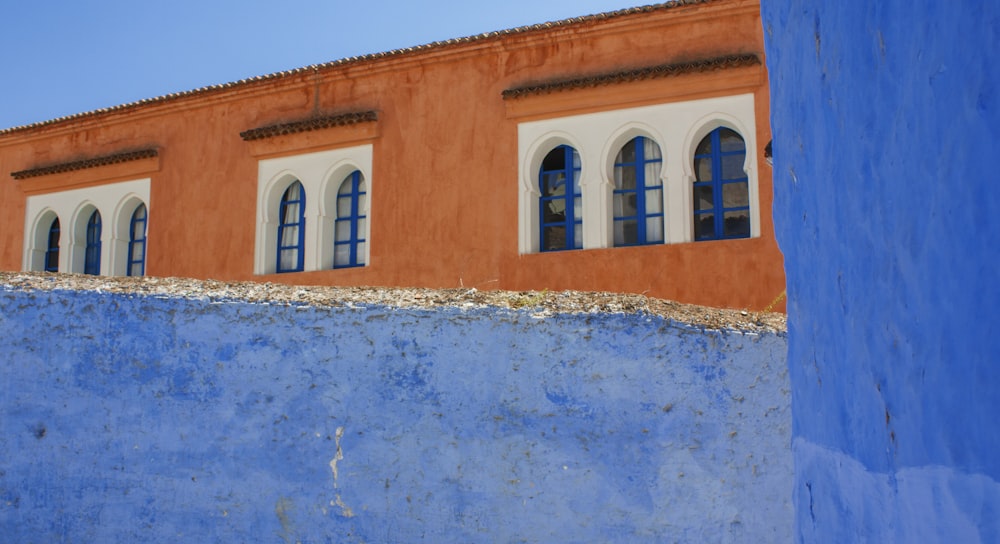 blue and brown concrete building under blue sky during daytime