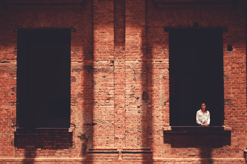 man in white shirt sitting on bench