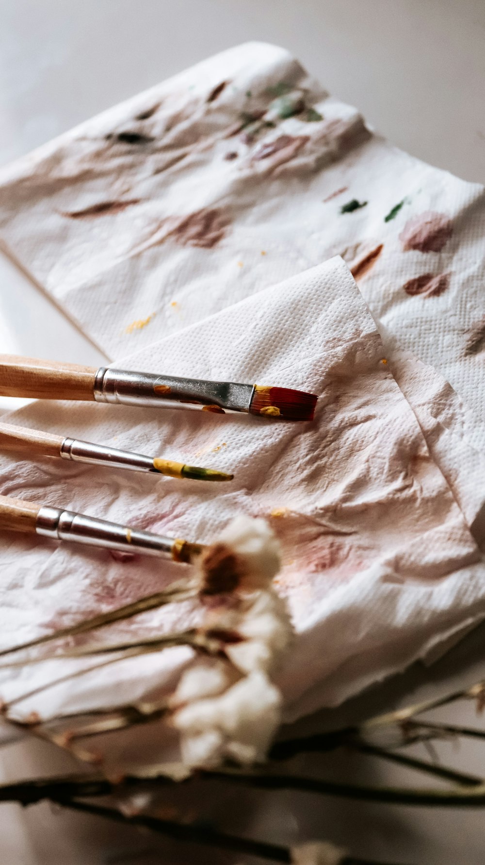 brown and silver makeup brush on white tissue paper