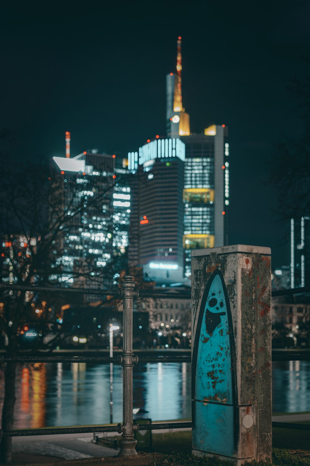 high rise building near body of water during night time