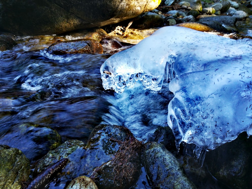 white and blue ice on gray rock