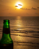 A serene sunset background with tdm sunshine bottles glowing softly in the fading light.