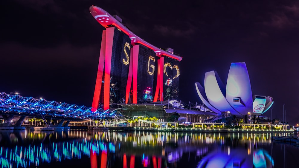 red and white building near body of water during night time