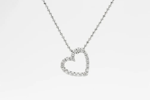 A delicate lab-grown diamond pendant glistening under soft light.