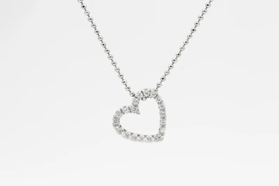 A modern CVD jewel pendant hanging delicately from a chain against a dark background