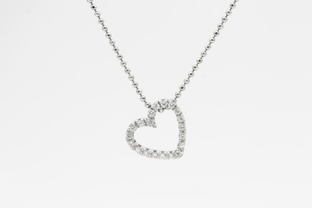 silver heart pendant necklace on white background