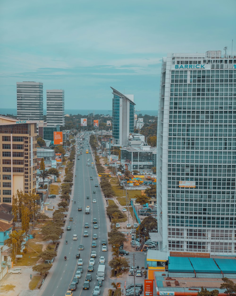 cars on road near high rise buildings during daytime