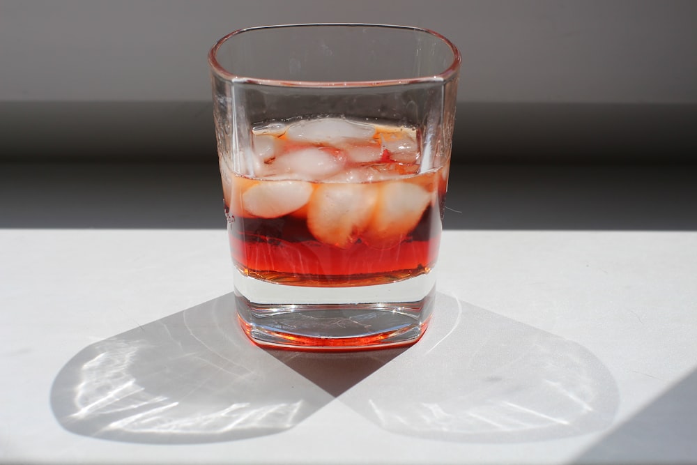 clear drinking glass with red liquid