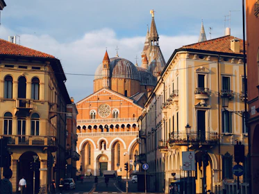 people walking on sidewalk near brown concrete building during daytime