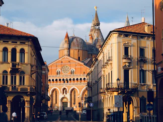 people walking on sidewalk near brown concrete building during daytime