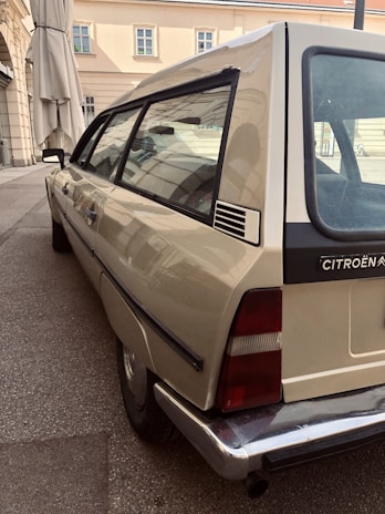 Friendly service staff assisting a customer next to their Citroen car in the service waiting area.