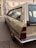 A classic Citroën car is parked on a paved street near a building with beige walls and multiple windows. The vehicle has a distinctive retro design, and the scene is calm with muted earth tones.
