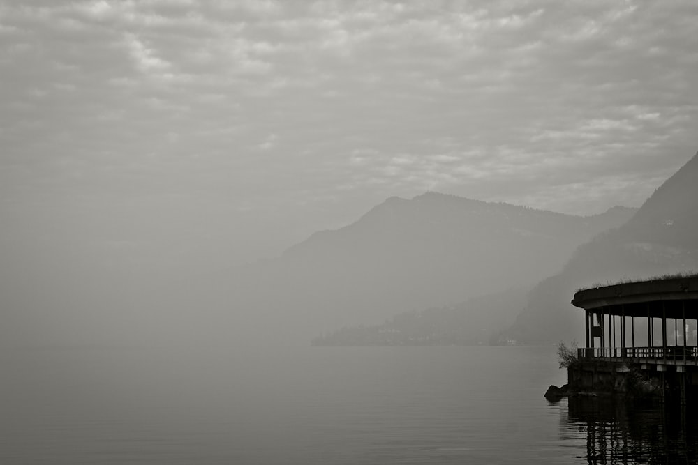 person riding on horse on lake near mountain during daytime