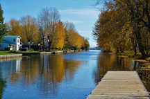Severn River with a wooden dock in the foreground and a waterfront home in the distance.