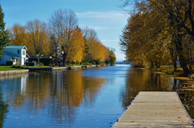 Severn River with a wooden dock in the foreground and a waterfront home in the distance.