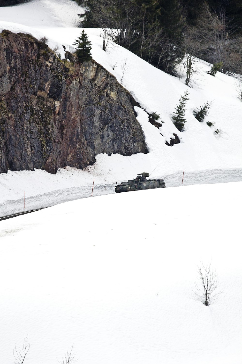 black car on snow covered ground during daytime