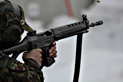 A close-up of a shooter aiming precisely during an IPSC competition at an outdoor range