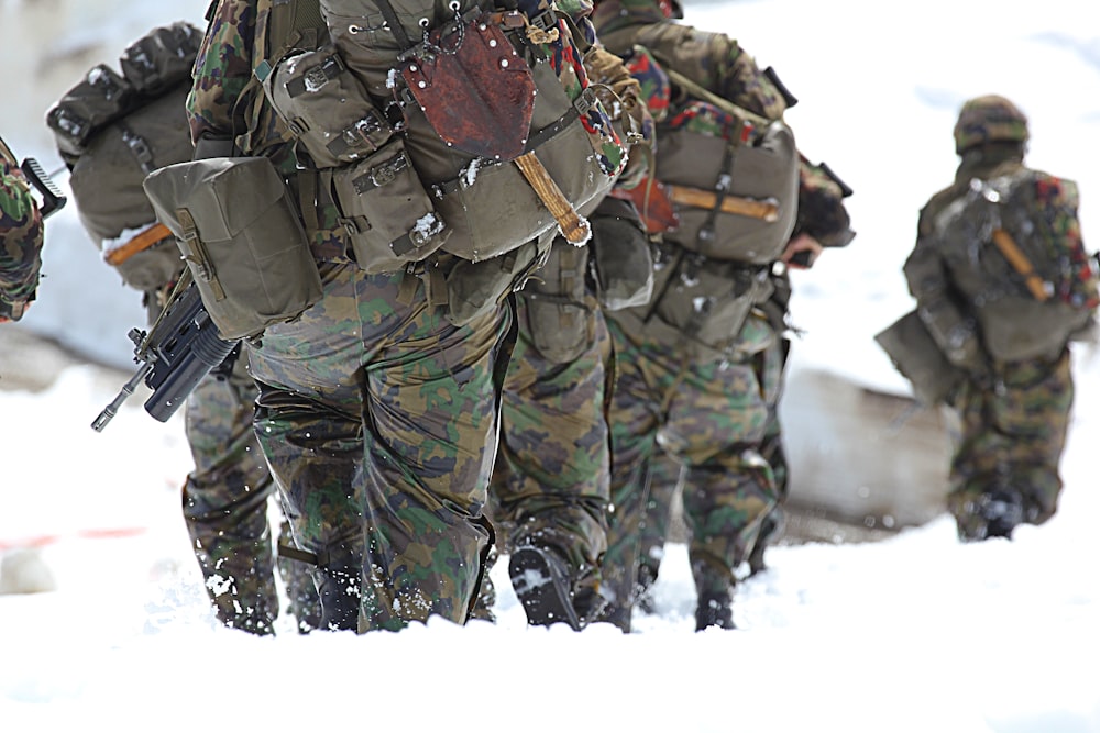 man in green black and brown camouflage uniform