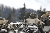 man in camouflage uniform holding rifle