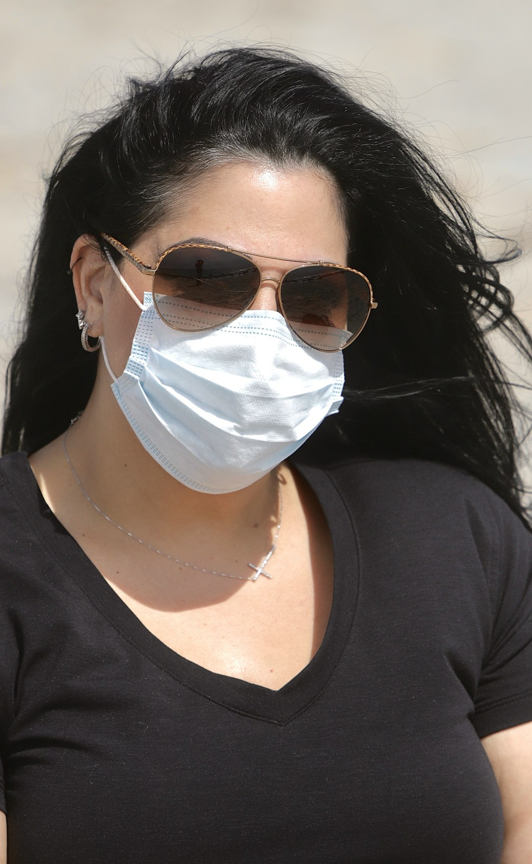 woman in black crew neck shirt wearing white face mask