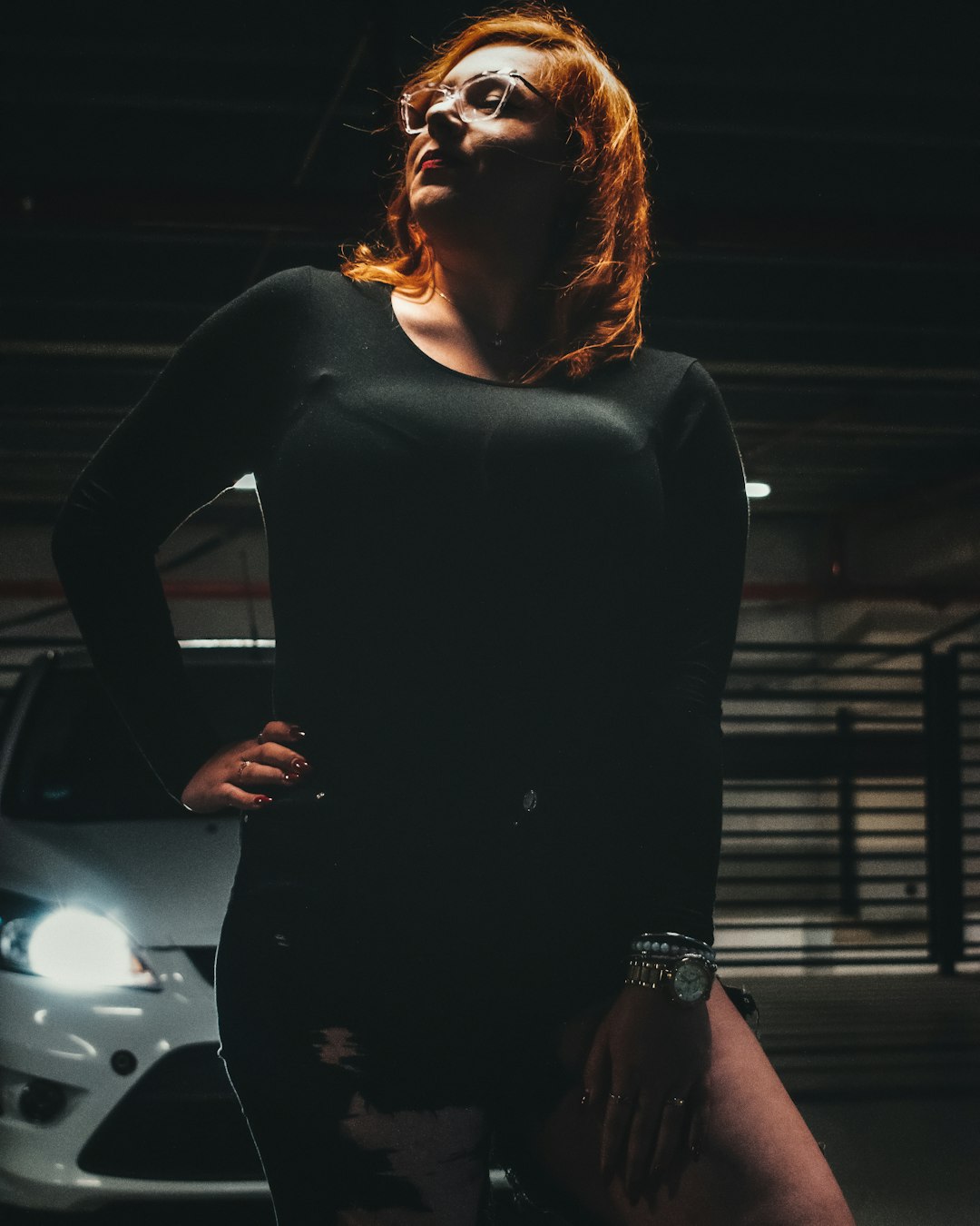 woman in black long sleeve dress standing beside silver car